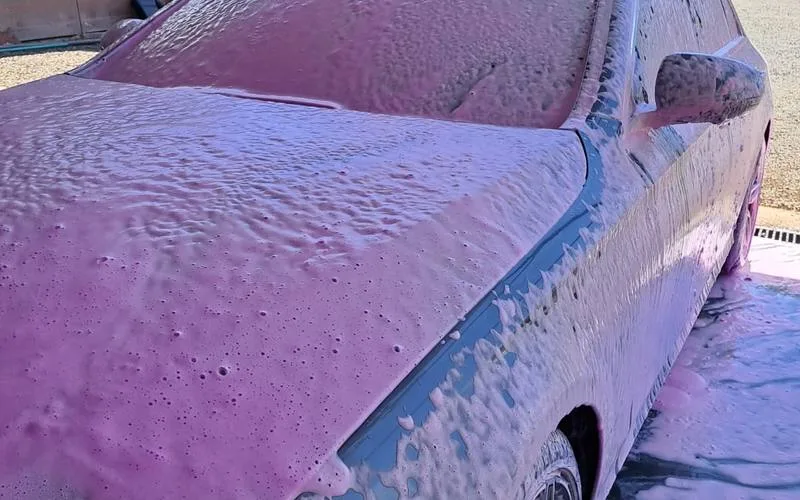 pH-neutral foam pre-wash applied to vehicle exterior during Indigo Car Care Club mobile detailing in Kisumu
